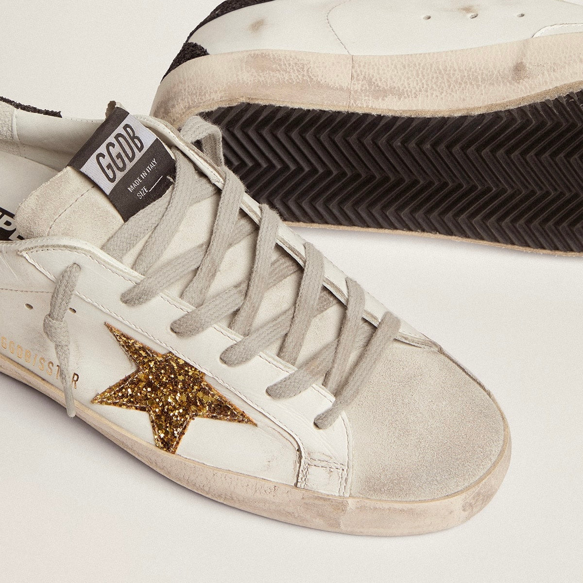 Golden Goose Super-Star in nappa leather with gold glitter star and black glitter heel tab(Women's)